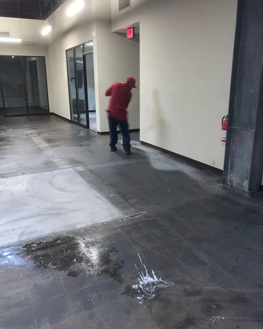 A crew member sweeping an emptied commercial unit