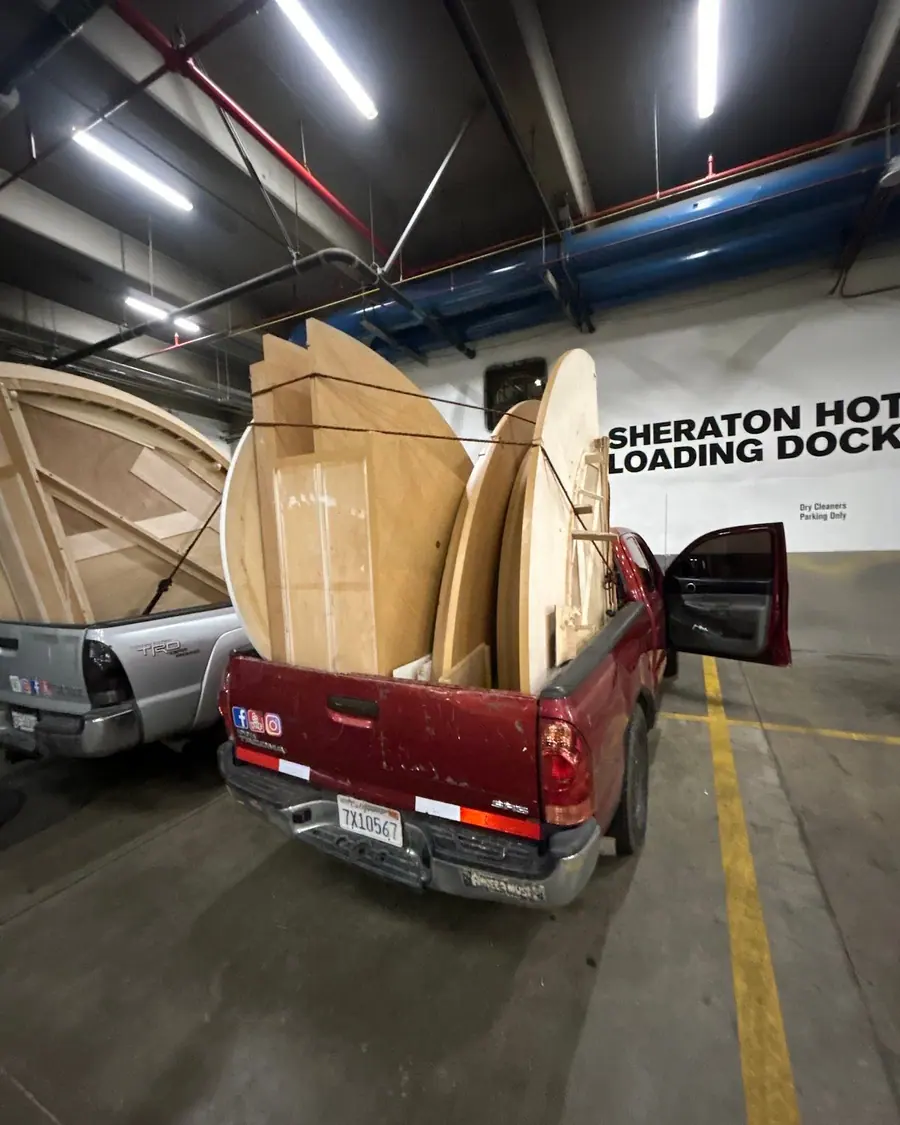 A pickup loaded with flattened cardboard at a hotel loading dock