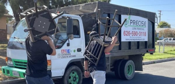 Precise Junk experts hauling off old furniture from garage cleanout services