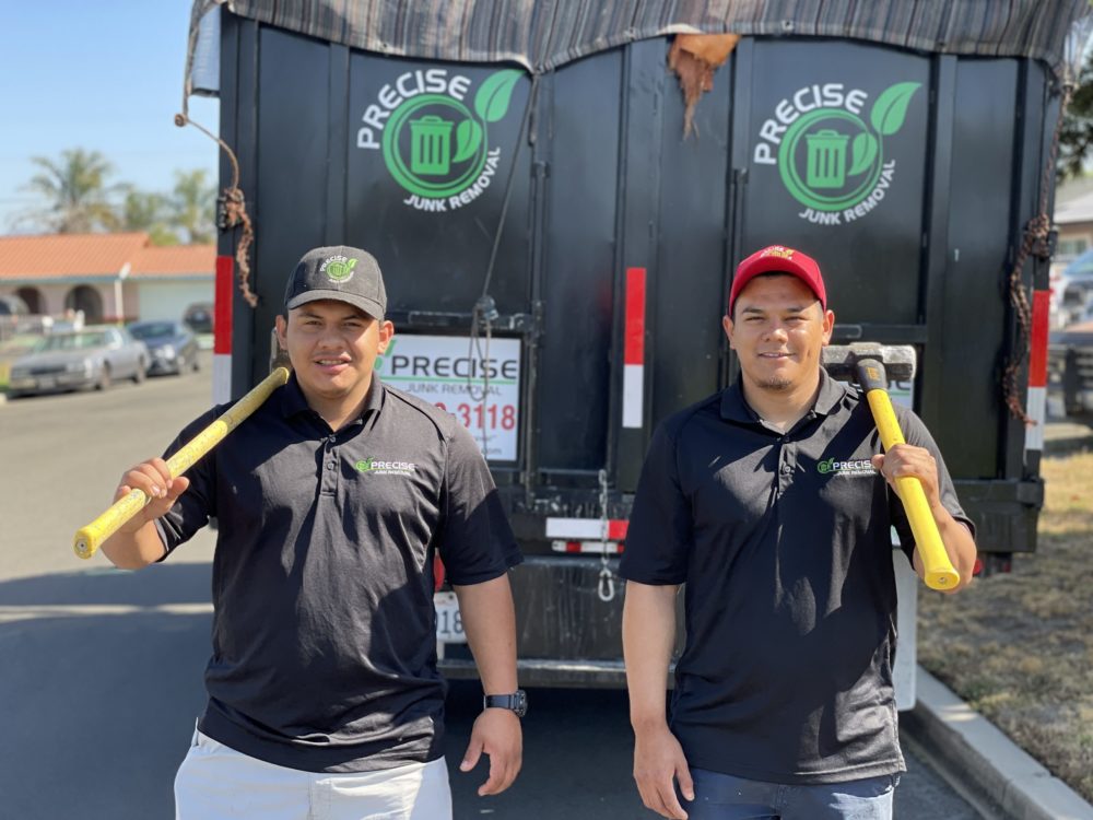 precise junk removal pros carrying tools