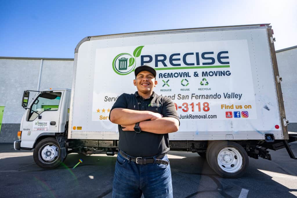 Precise Junk Removal Pro standing in front of truck